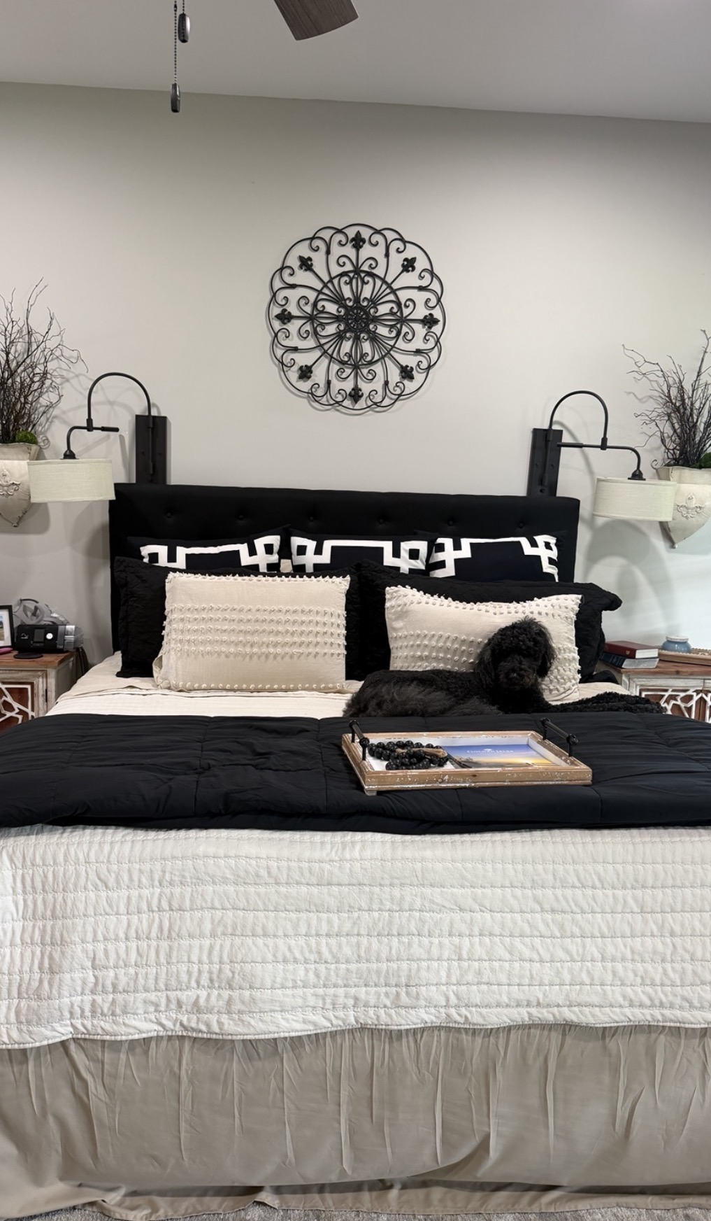 Neatly made bedroom with dog